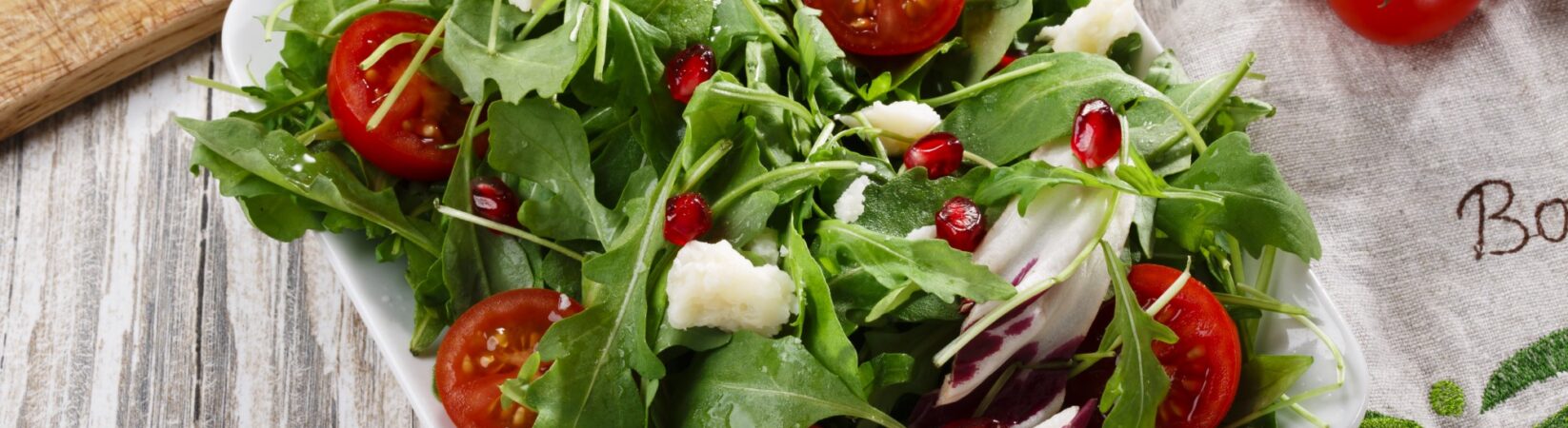 Salat mit Tomaten, Parmesan, Rucola und Granatapfel